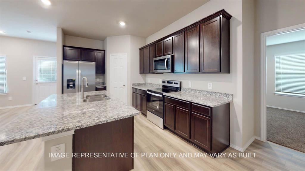 3201 Cyprian Road Lorena, TX 76655 - Photo 7 of 27 a kitchen with stainless steel appliances granite countertop a sink stove and refrigerator