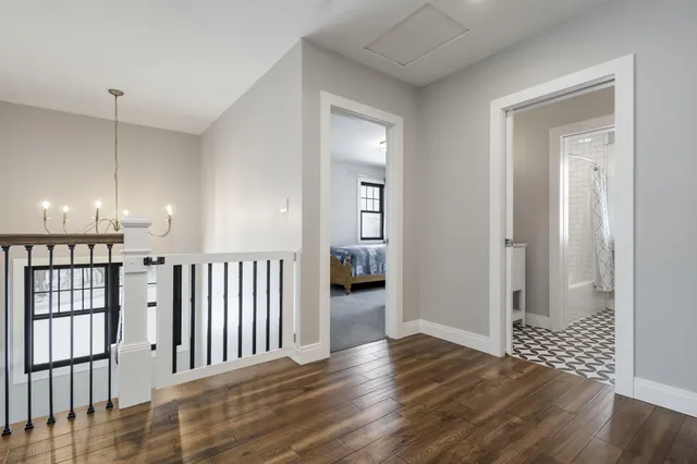 a view of hallway with wooden floor