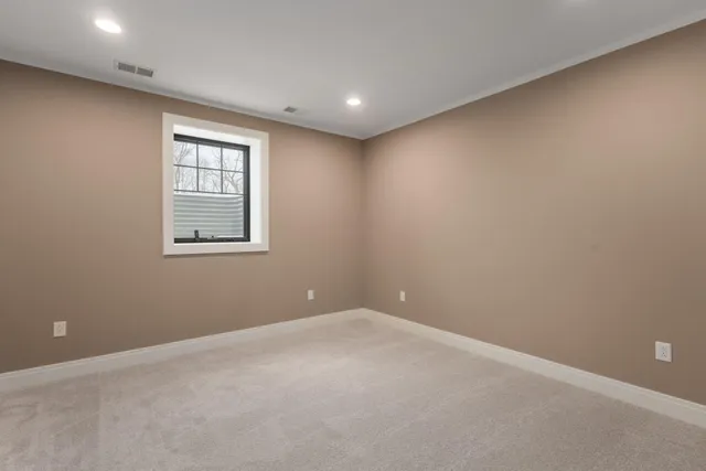 a view of a house with chairs and a yard with a fountain