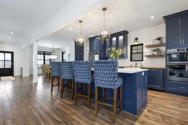 a view of a dining room with furniture wooden floor and chandelier