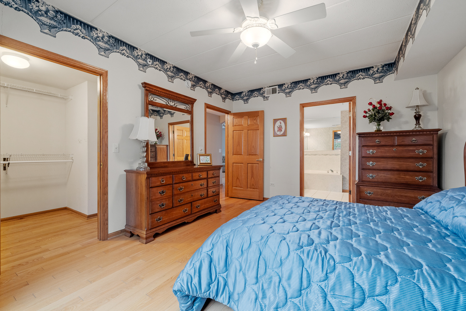 7912 Trinity Circle, Unit 1NW Tinley Park, IL 60487 - Photo 11 of 20 a bedroom with a bed and a dresser