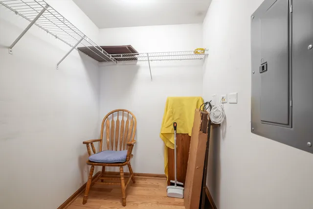 a view of a hallway with wooden chairs
