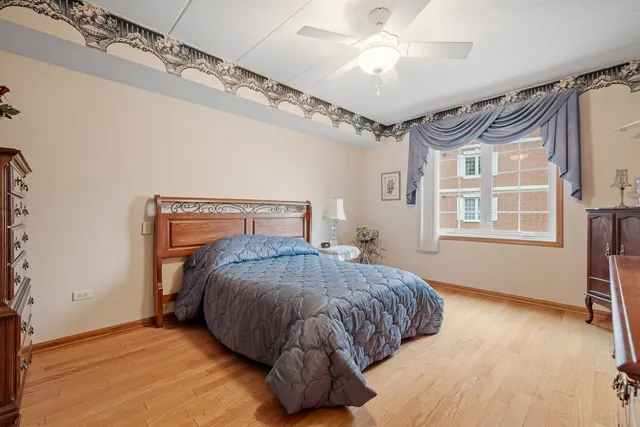 a bedroom with a bed mirror and window