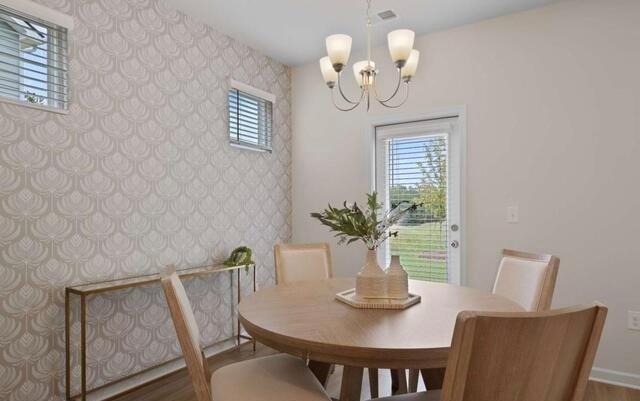 1290 Harmony Rdg Court Jonesboro, GA 30238 - Photo 14 of 29 a view of a dining room with furniture a chandelier and wooden floor