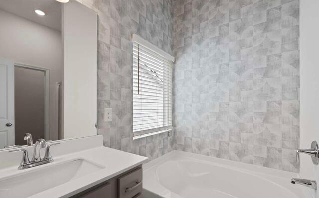 1290 Harmony Rdg Court Jonesboro, GA 30238 - Photo 25 of 29 a bathroom with a sink and a bathtub