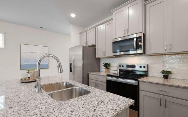 1290 Harmony Rdg Court Jonesboro, GA 30238 - Photo 4 of 29 a kitchen with stainless steel appliances granite countertop a sink a stove and a refrigerator