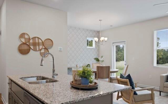 1290 Harmony Rdg Court Jonesboro, GA 30238 - Photo 7 of 29 a kitchen with a granite countertop sink a table and chairs
