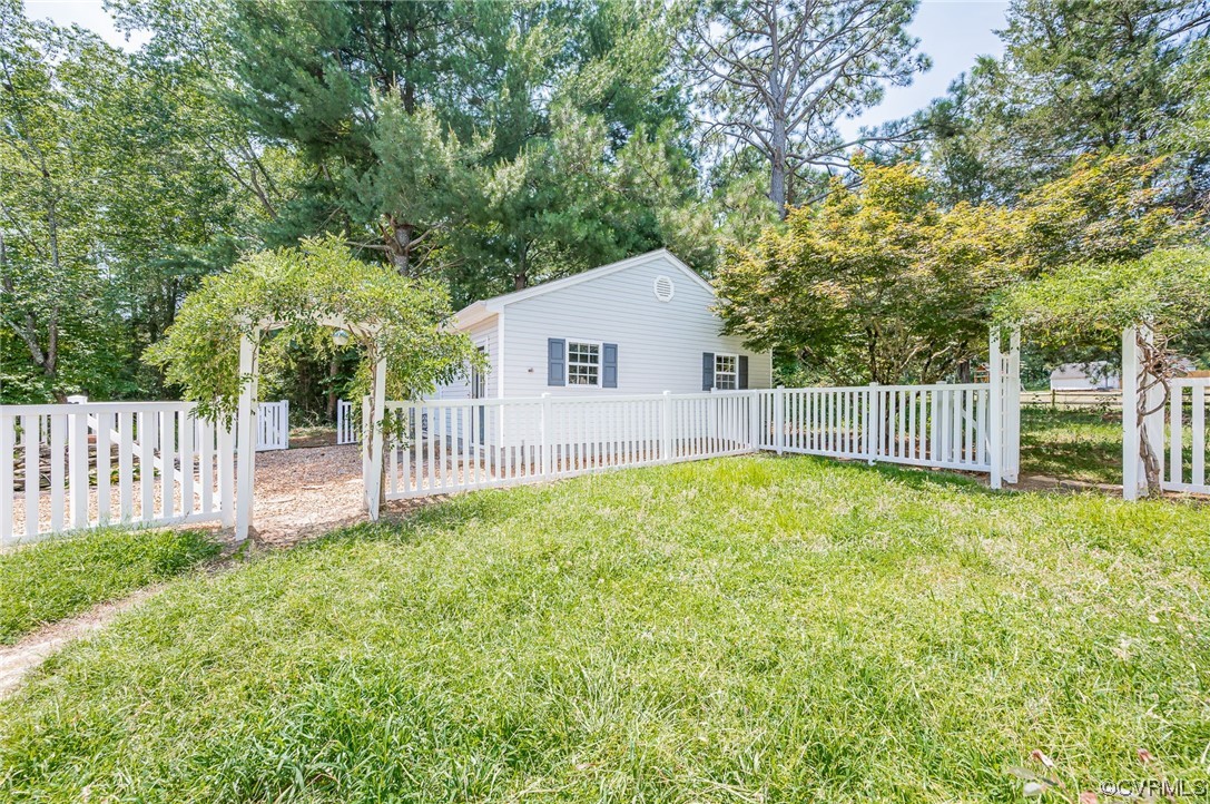 3741 Harrow Drive Chester, VA 23831 - Photo 31 of 37 a view of backyard with small cabin and wooden fence