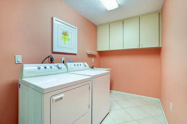 a utility room with a sink washer and dryer