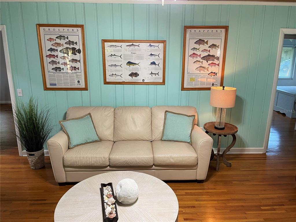 1963 Ripon Drive Clearwater, FL 33764 - Photo 11 of 29 a living room with furniture a couch and paintings on the wall
