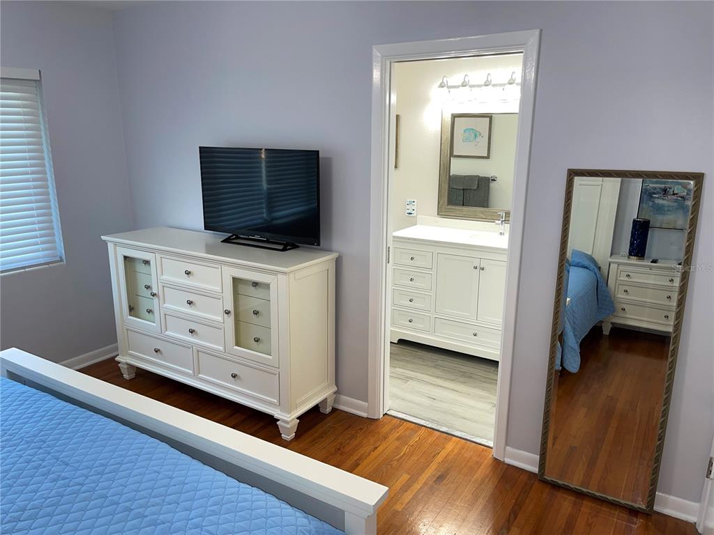1963 Ripon Drive Clearwater, FL 33764 - Photo 12 of 29 a view of bedroom with furniture and flat screen tv