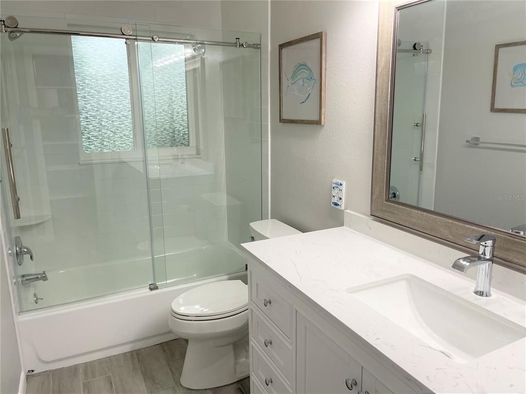 1963 Ripon Drive Clearwater, FL 33764 - Photo 14 of 29 a bathroom with a sink a toilet and shower