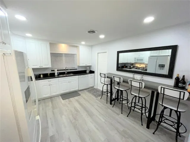 a kitchen with a table and chairs in it