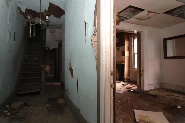 a view of hallway with stairs and wooden floor
