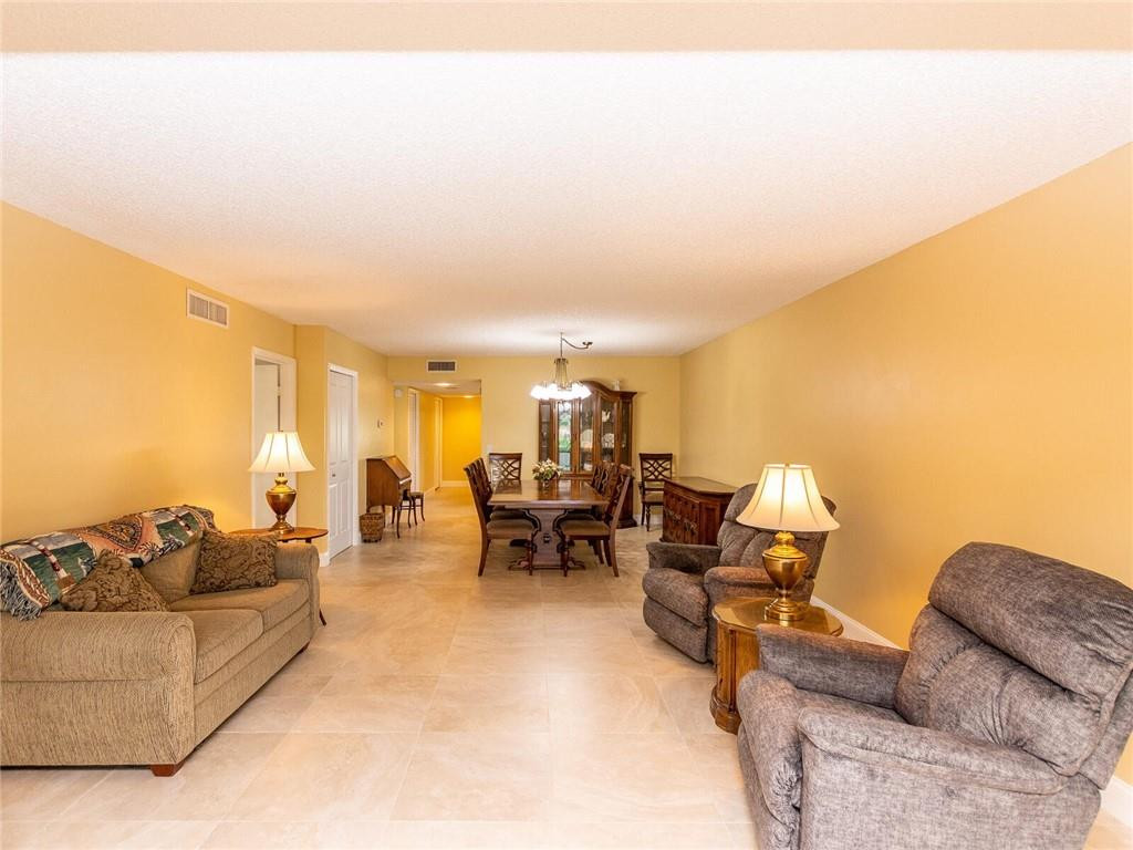 340 Racquet Club Road, Unit 103 Weston, FL 33326 - Photo 2 of 39 a living room with furniture and a large window