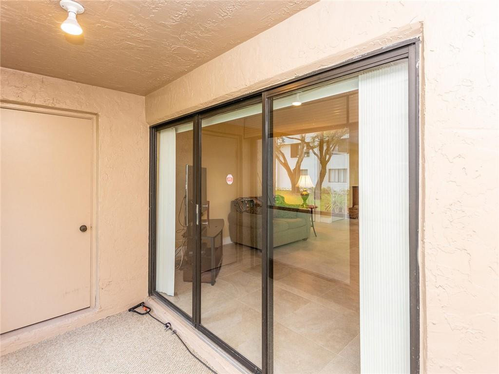 340 Racquet Club Road, Unit 103 Weston, FL 33326 - Photo 25 of 39 a bathroom with a glass shower door and mirror