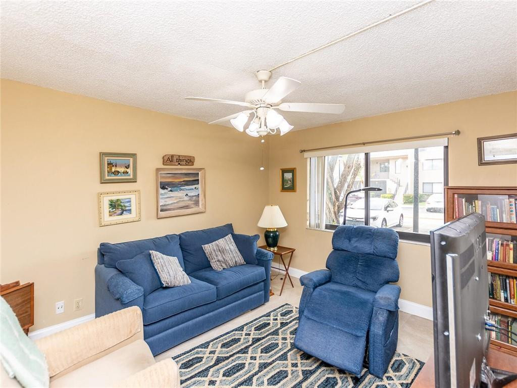 340 Racquet Club Road, Unit 103 Weston, FL 33326 - Photo 34 of 39 a living room with furniture a large window with a rug