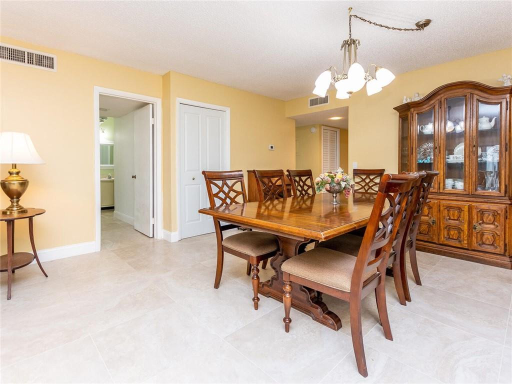 340 Racquet Club Road, Unit 103 Weston, FL 33326 - Photo 6 of 39 a view of a dining room with furniture and chandelier