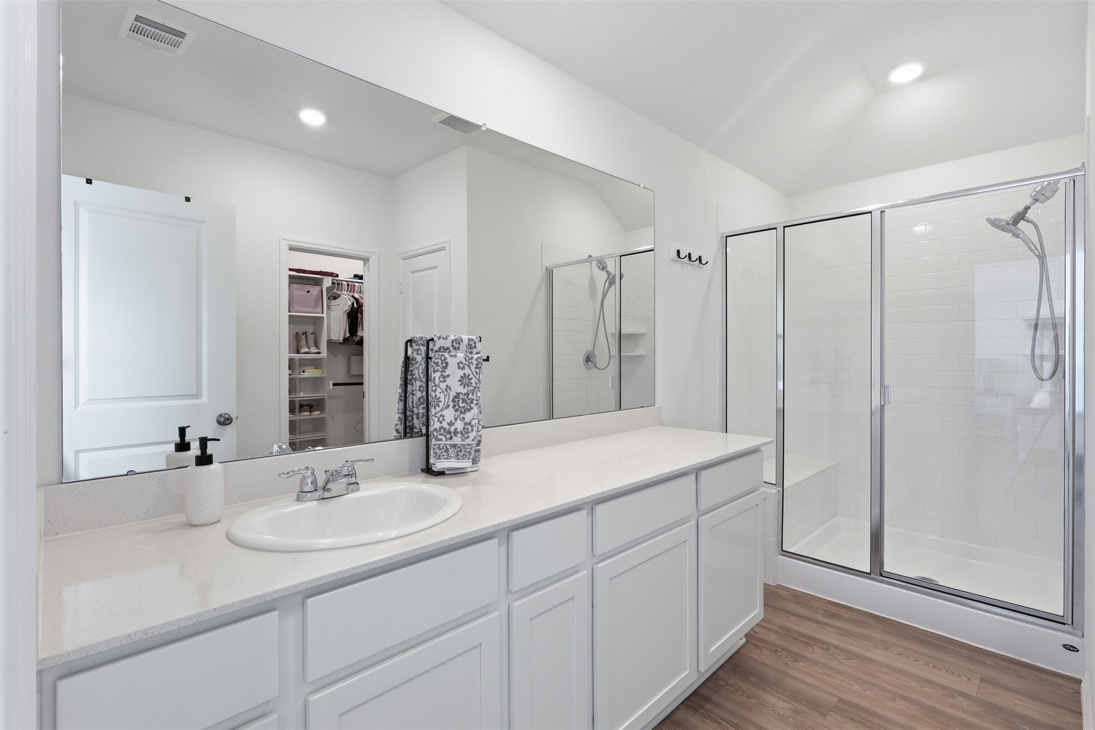 3727 Moss Hl Road Rosenberg, TX 77469 - Photo 16 of 32 The primary en-suite bathroom features a spacious vanity with ample storage, a glass-enclosed shower with subway tile, and access to a large walk-in closet.