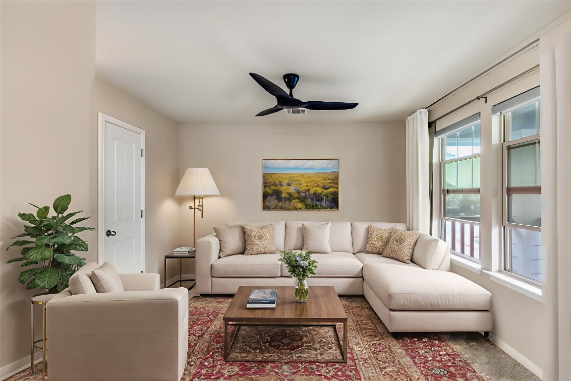 4607 Truth Way, Unit 440 Austin, TX 78725 - Photo 18 of 30 a living room with furniture and a large window