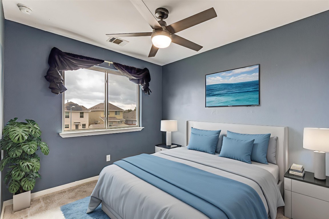 4607 Truth Way, Unit 440 Austin, TX 78725 - Photo 20 of 30 a bedroom with a large bed and a window