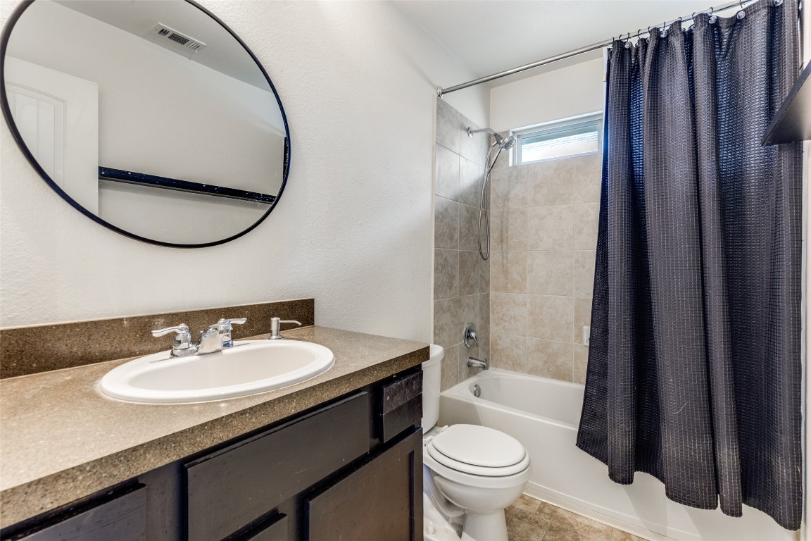 4607 Truth Way, Unit 440 Austin, TX 78725 - Photo 23 of 30 a bathroom with a sink toilet and shower
