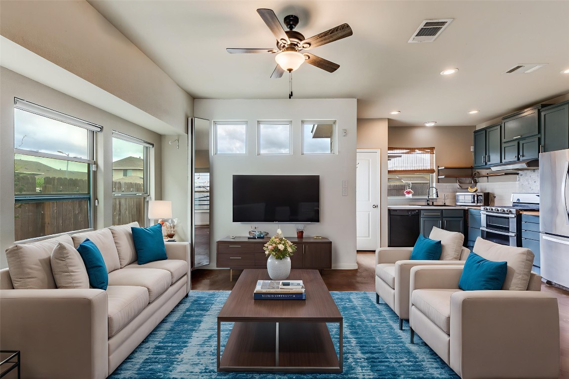 4607 Truth Way, Unit 440 Austin, TX 78725 - Photo 6 of 30 a living room with furniture a flat screen tv and a large window
