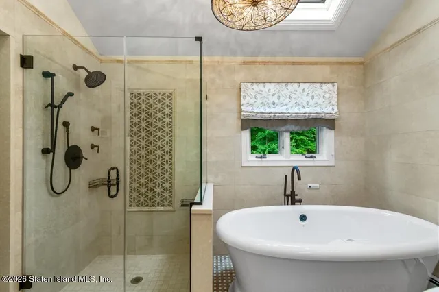 a bathroom with a sink and mirror with bathtub