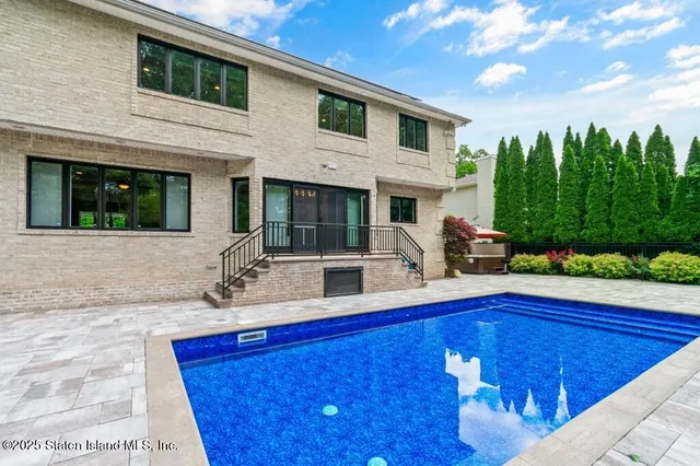 a small swimming pool with an outdoor seating