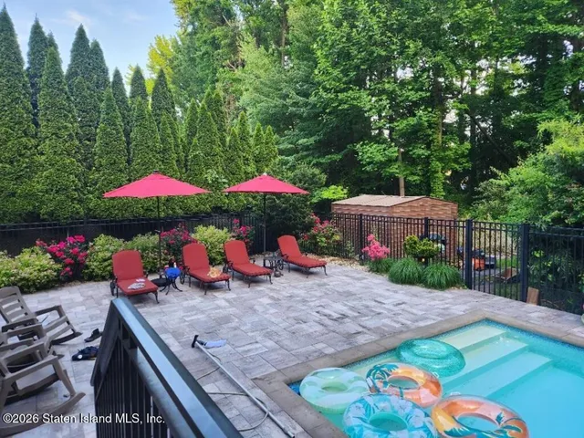 a small swimming pool with an outdoor seating