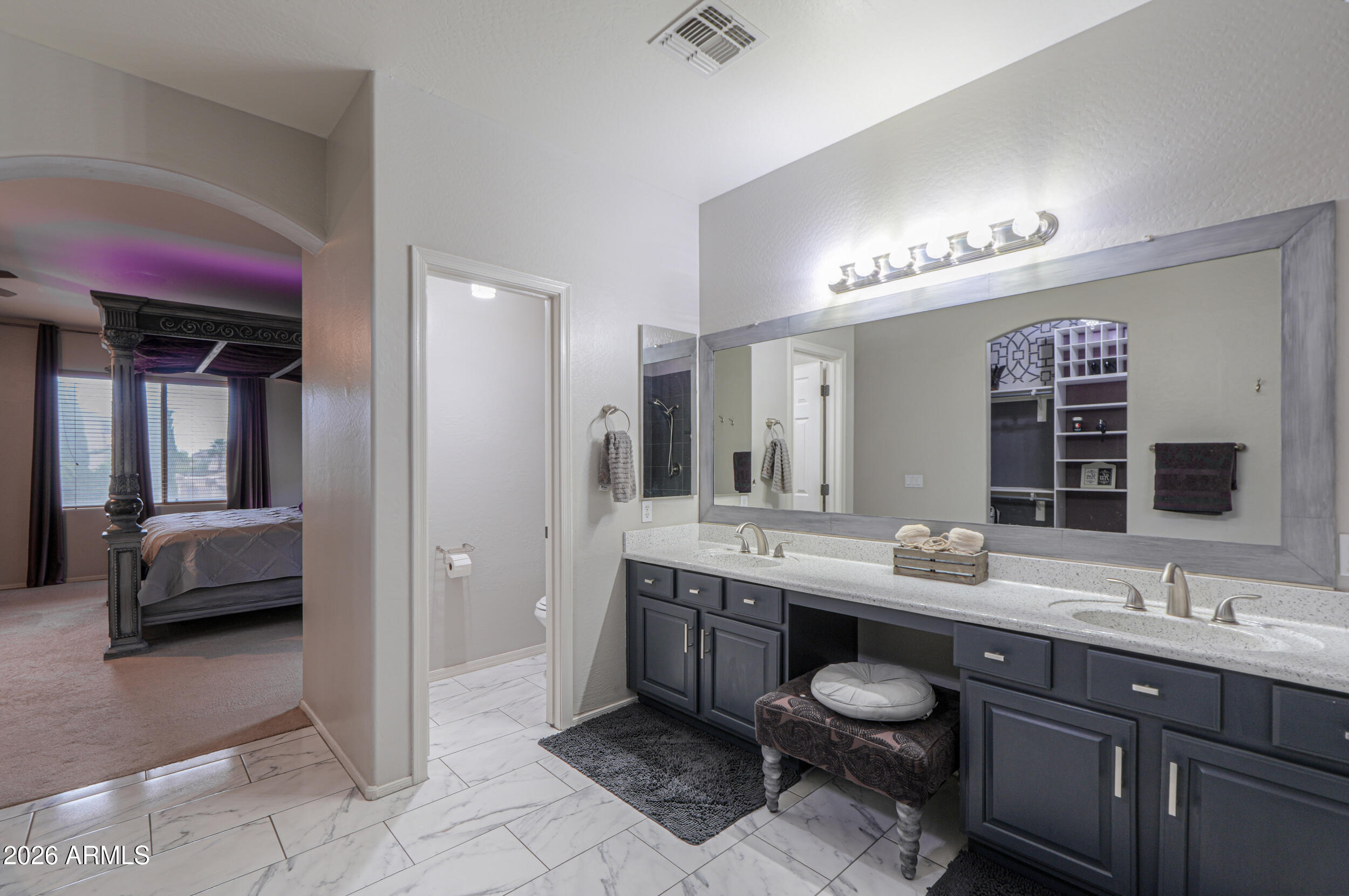 45247 West Jack Rabbit Trail Maricopa, AZ 85139 - Photo 53 of 75 a spacious bathroom with a granite countertop sink and a mirror