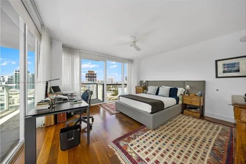 a bedroom with a bed and a television