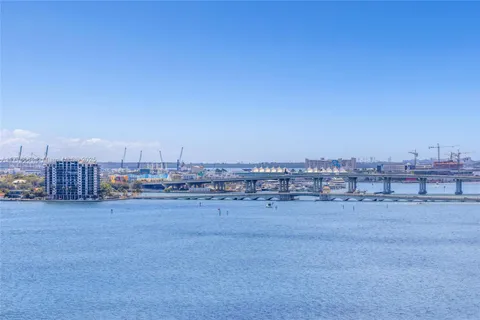 a view of a city with tall buildings and a bench