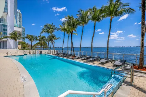 a view of swimming pool with a table and chairs