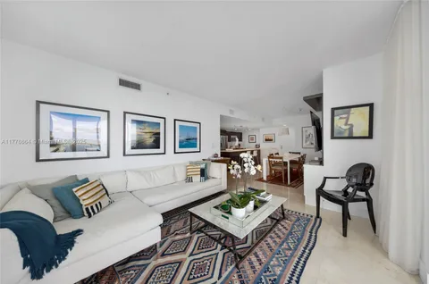 a room with lots of potted plants a rug and a shower