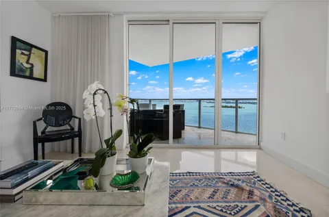 a view of a dining room with furniture and a flat screen tv