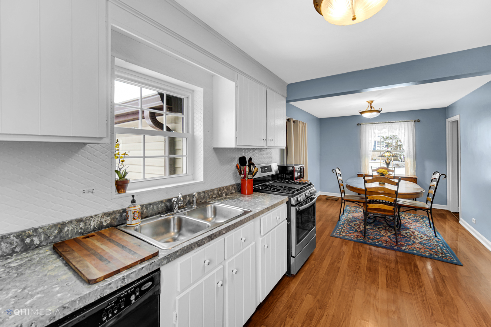 1118 Manchester Road Wheaton, IL 60187 - Photo 11 of 19 a kitchen that has a sink and a stove in it