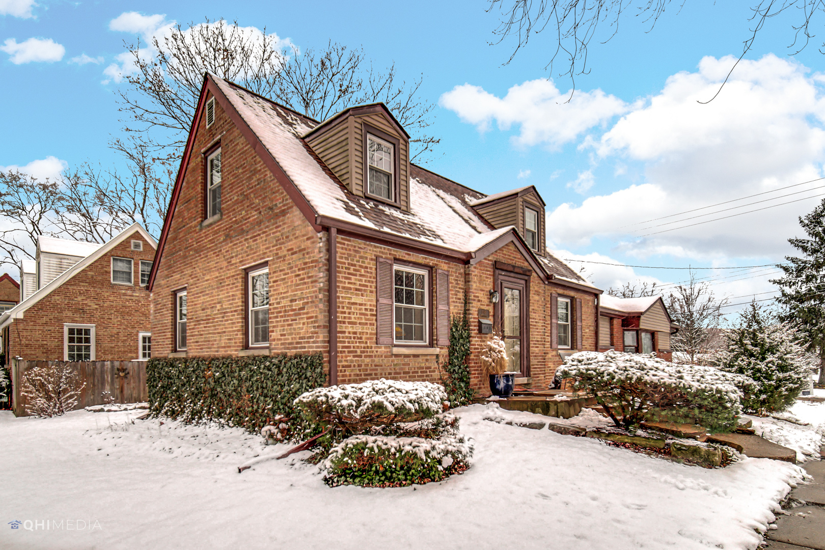 1118 Manchester Road Wheaton, IL 60187 - Photo 4 of 19 a front view of a house with a yard covered in snow