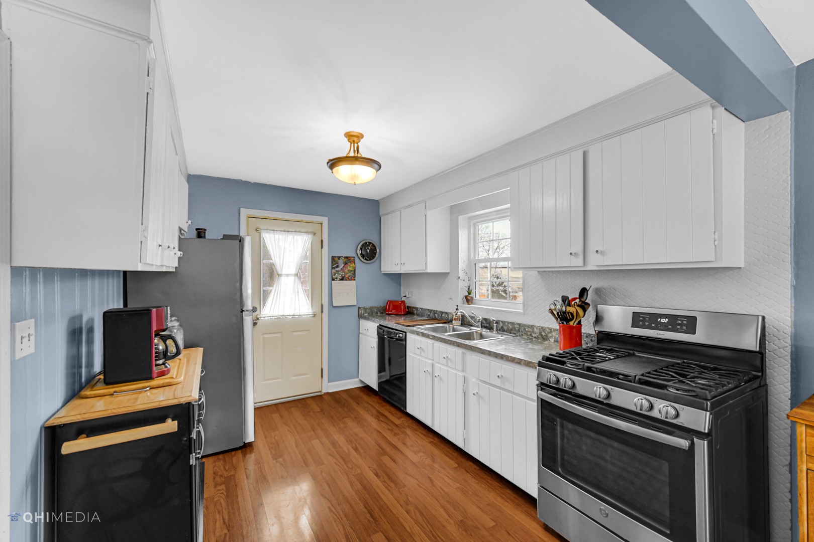 1118 Manchester Road Wheaton, IL 60187 - Photo 10 of 19 a kitchen with a sink cabinets and wooden floor