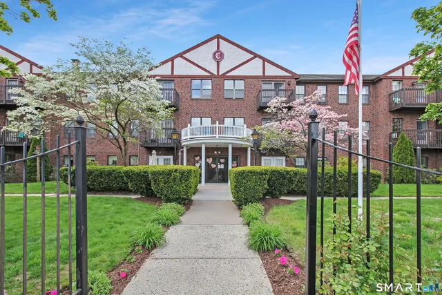 a front view of a house with a garden and pathway