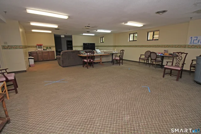 a bedroom with furniture and a book shelf