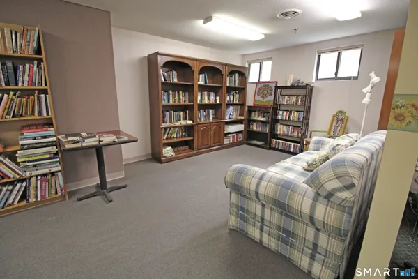 a reading room with furniture and a book shelf