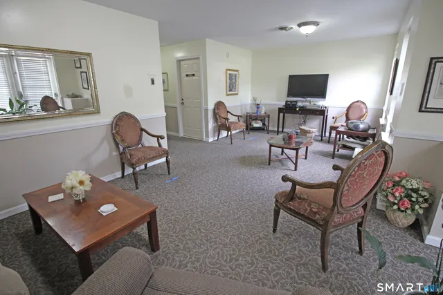 a living room with furniture a table and chairs
