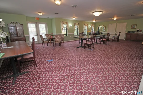 a living room with furniture a table and chairs