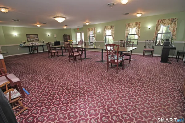 a lobby with furniture and floor to ceiling window