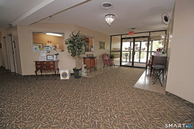 a view of a patio with a table and chairs under an umbrella