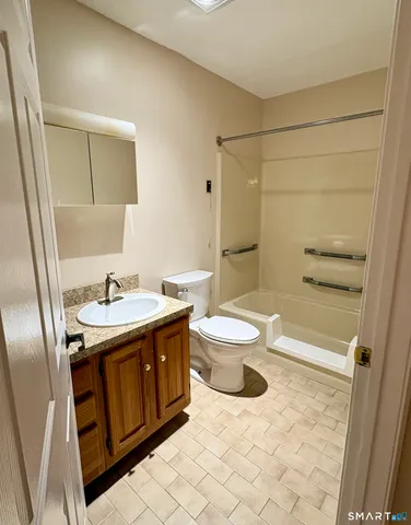 a view of building with cars parked in front of it