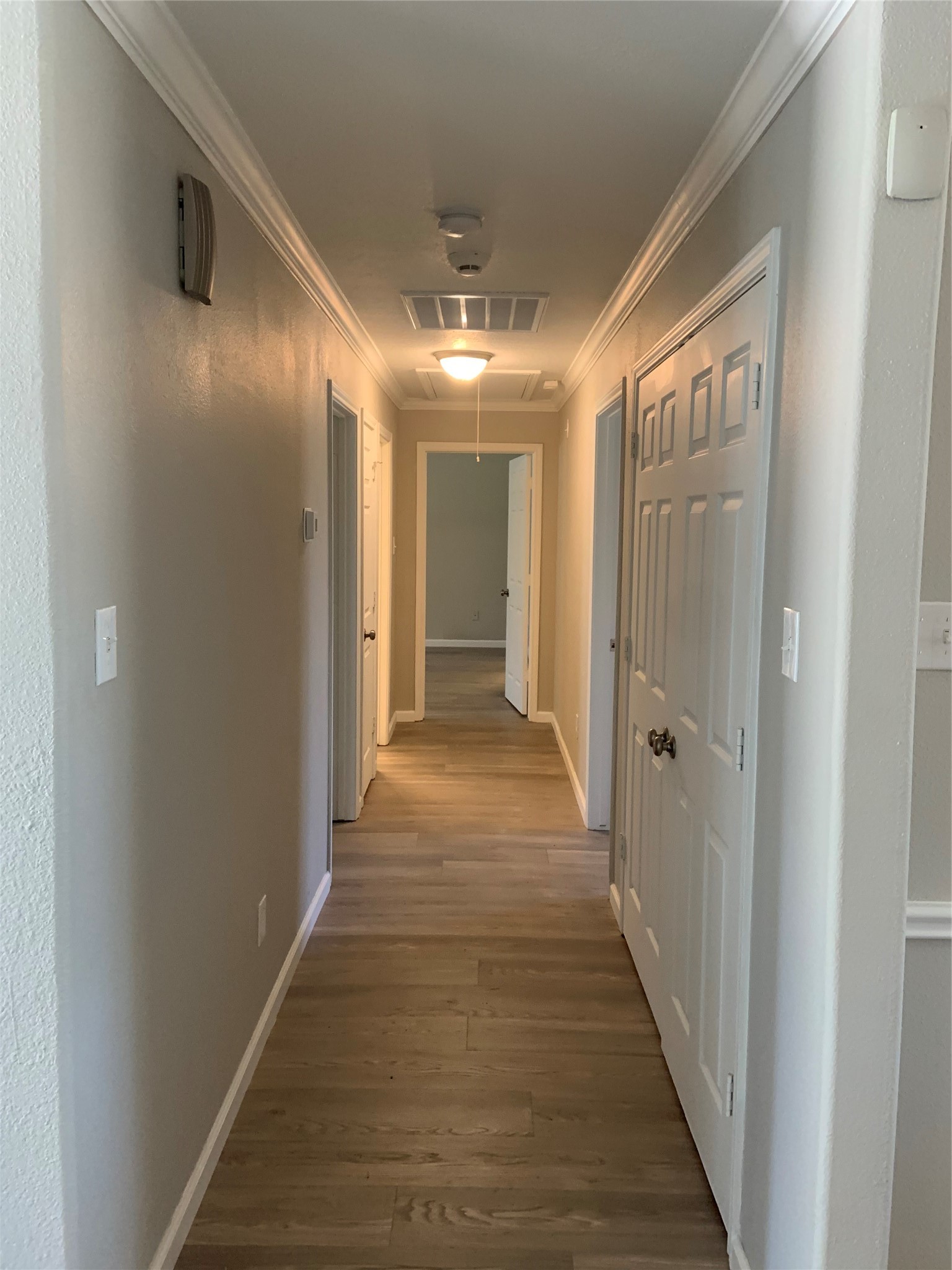 10978 Youpon Street Cleveland, TX 77328 - Photo 12 of 24 a view of a hallway with wooden floor
