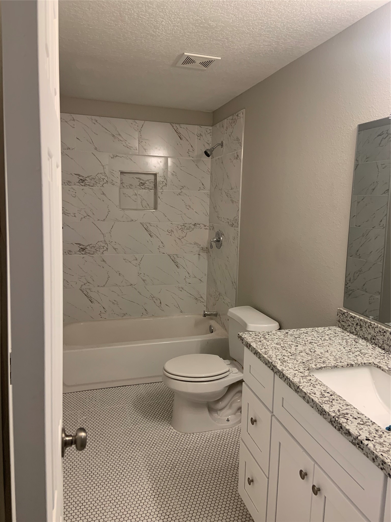 10978 Youpon Street Cleveland, TX 77328 - Photo 15 of 24 a bathroom with a granite countertop sink a toilet a mirror and bathtub
