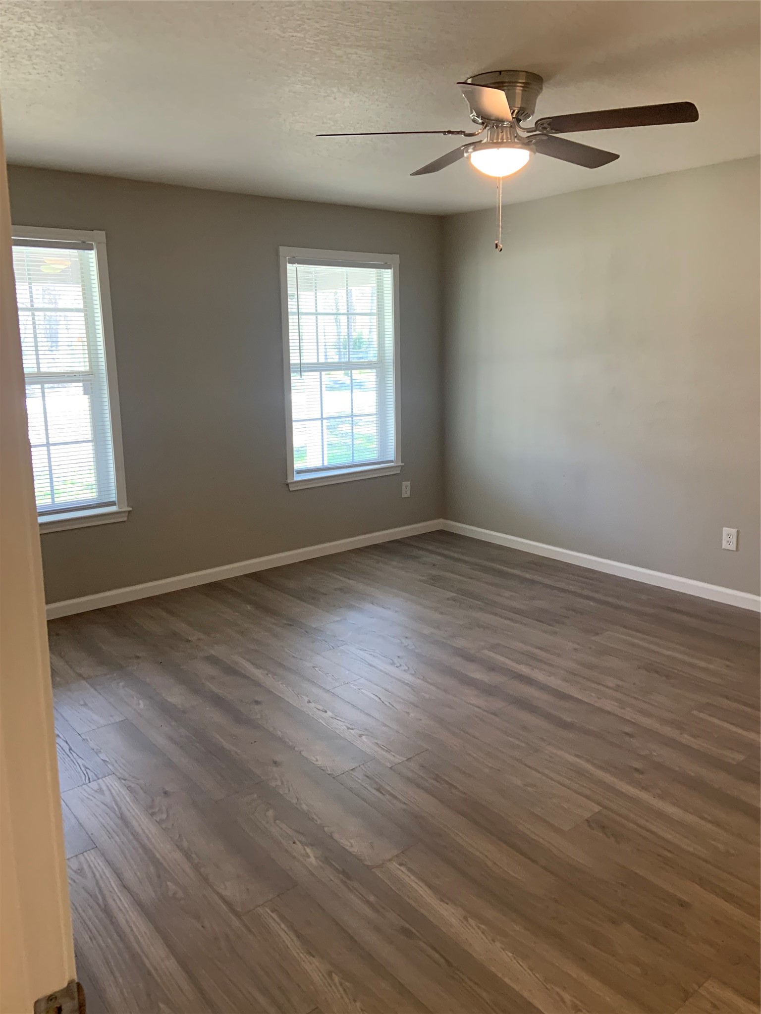 10978 Youpon Street Cleveland, TX 77328 - Photo 16 of 24 wooden floor in an empty room with a window